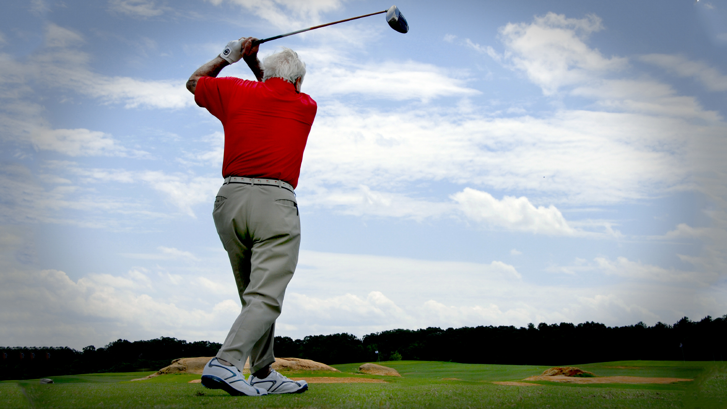 A man practices his golf swing on Lonnie Poole Golf Course.