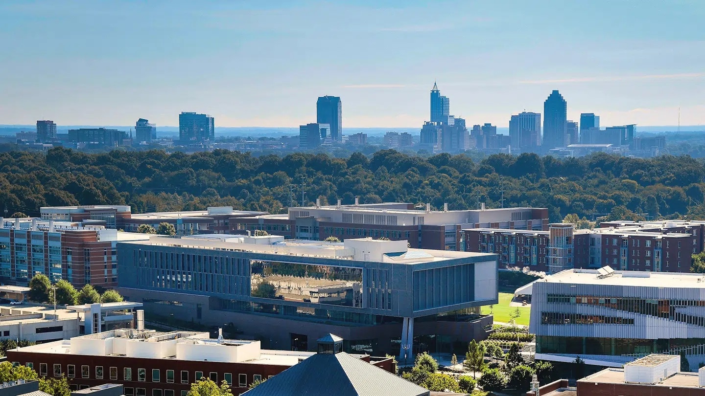 An aerial view of Centennial Campus with the skyline of downtown Raleigh in the background.