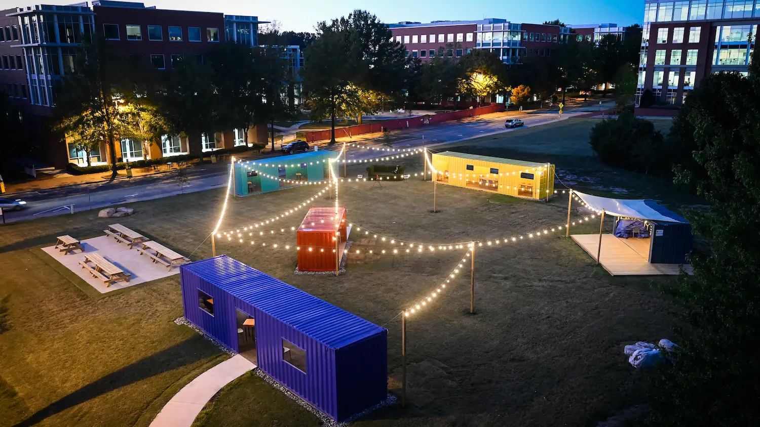 The Corner, an open-air gathering space for the Centennial Campus community, lit up at night.