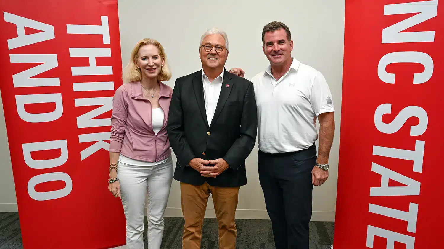 Chancellor Woodson (center) with Under Armour Founder, Executive Chairman and Brand Chief Kevin Plank (right) and President and CEO Stephanie Linnartz (left).