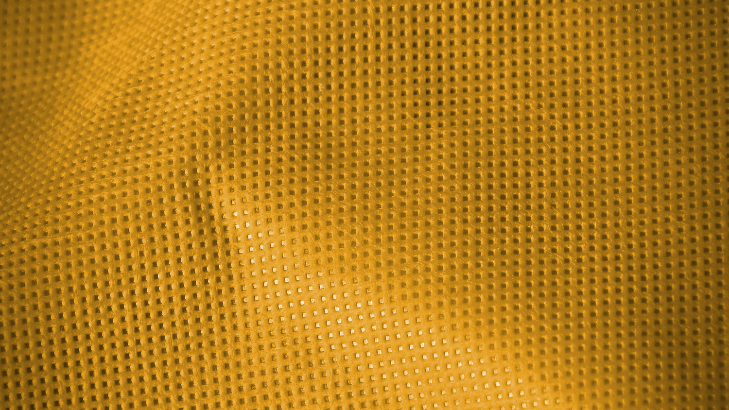 A textural, bright yellow nonwoven textile.