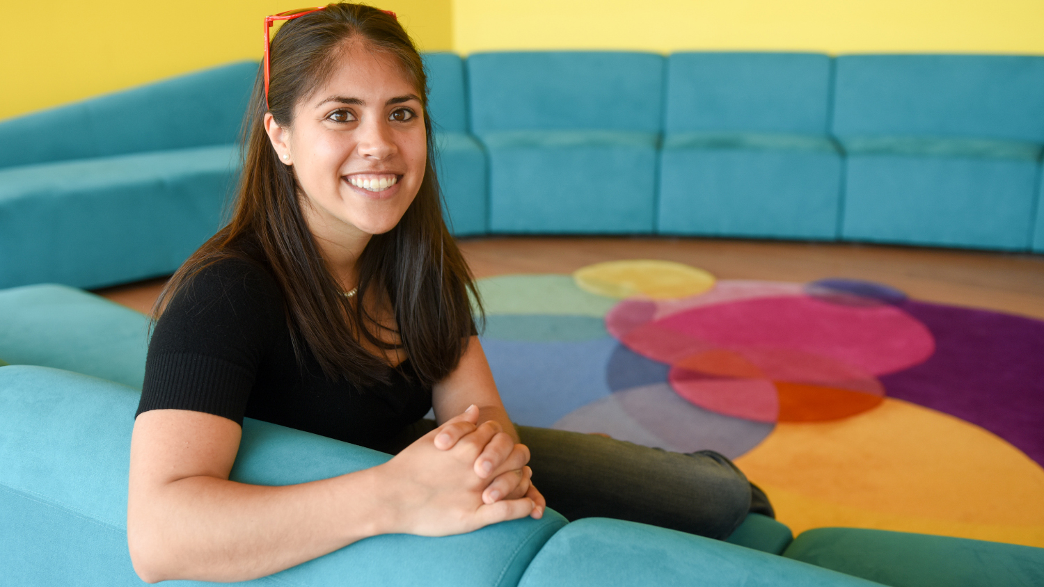 A student sits in a colorful room in the Hunt Library.