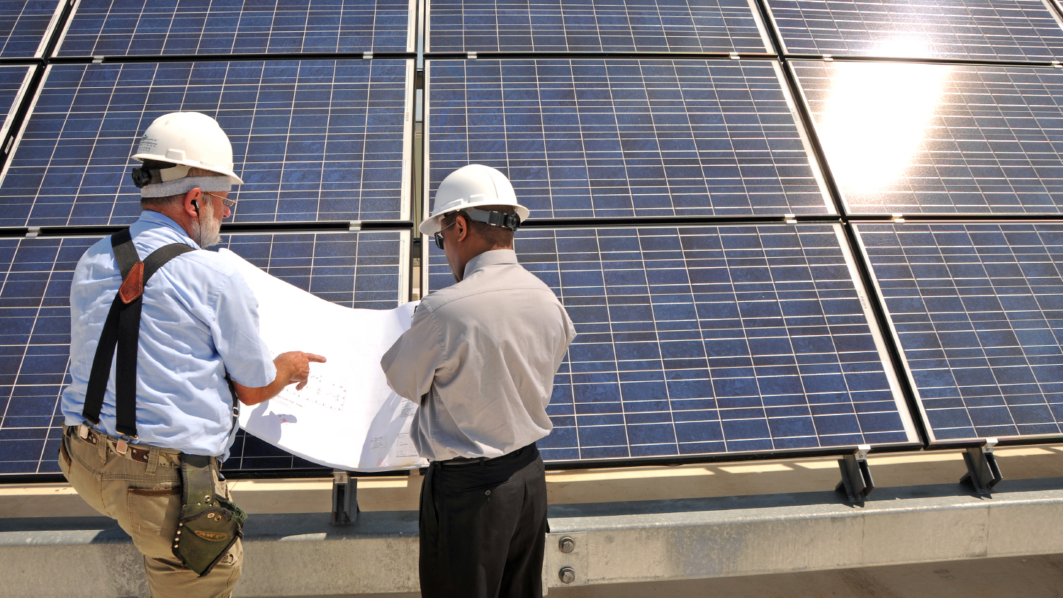 Researchers work on solar panels.