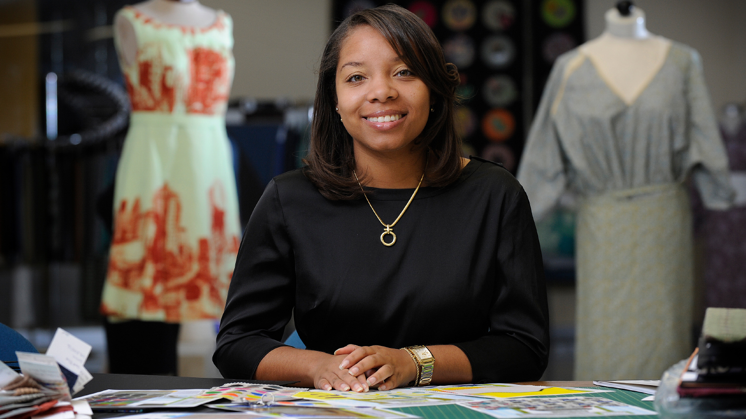 A fashion designer works on her boutique clothing line.