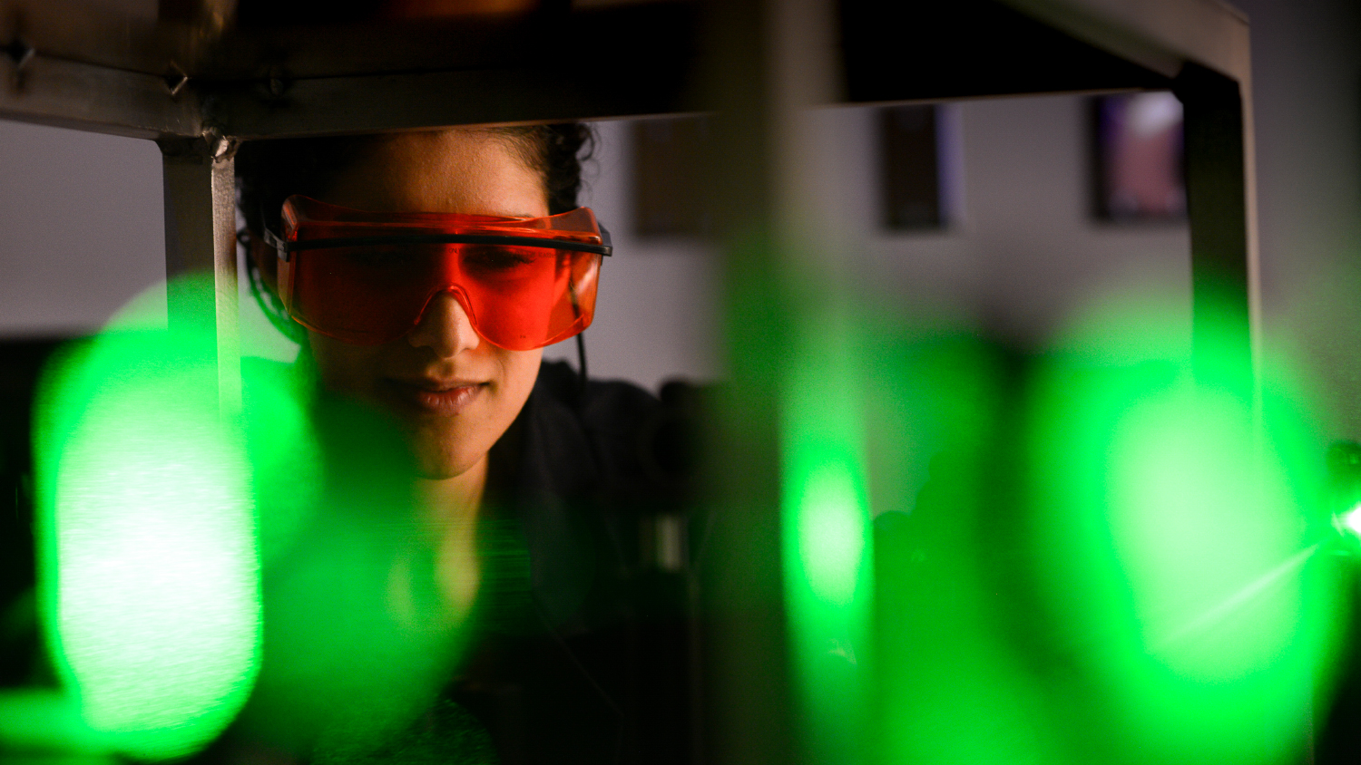 A researcher studies lasers.